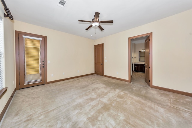 unfurnished room featuring light colored carpet and ceiling fan