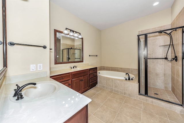 bathroom with tile patterned flooring, shower with separate bathtub, and vanity