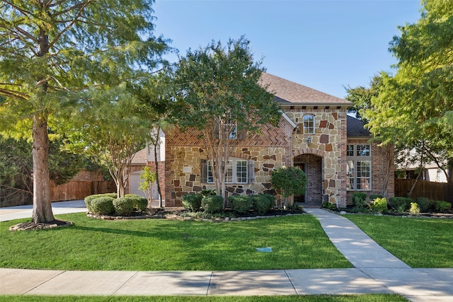 view of front facade with a garage and a front yard