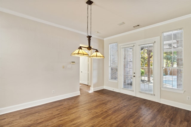 unfurnished dining area with ornamental molding and dark hardwood / wood-style floors