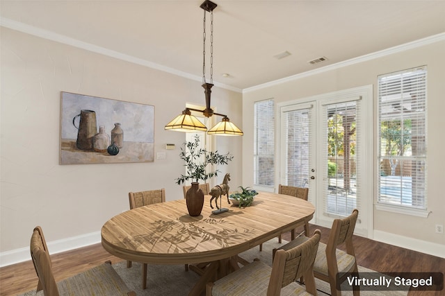 dining space with ornamental molding and hardwood / wood-style floors