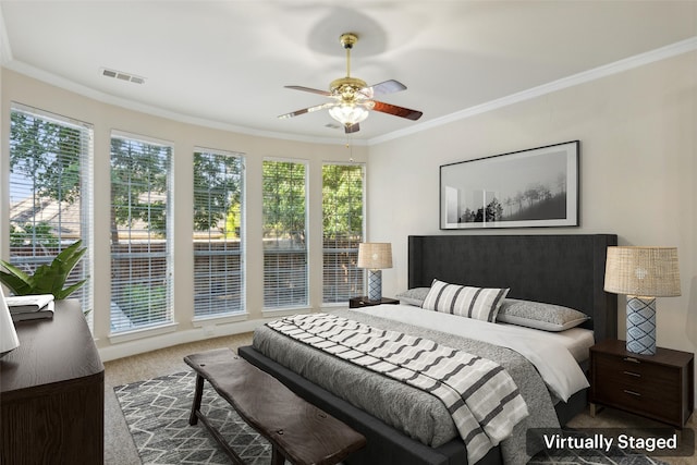 carpeted bedroom featuring crown molding and ceiling fan