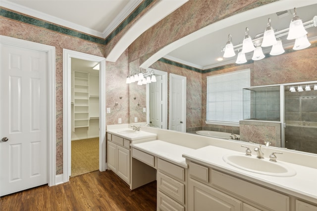 bathroom with vanity, hardwood / wood-style flooring, a shower with shower door, and ornamental molding