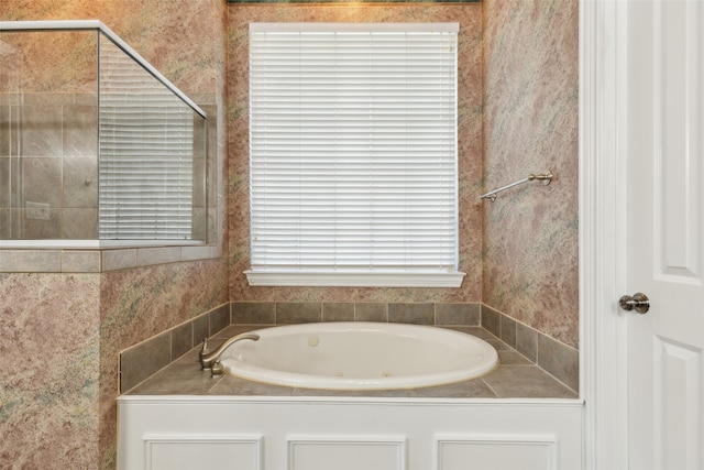 bathroom featuring shower with separate bathtub