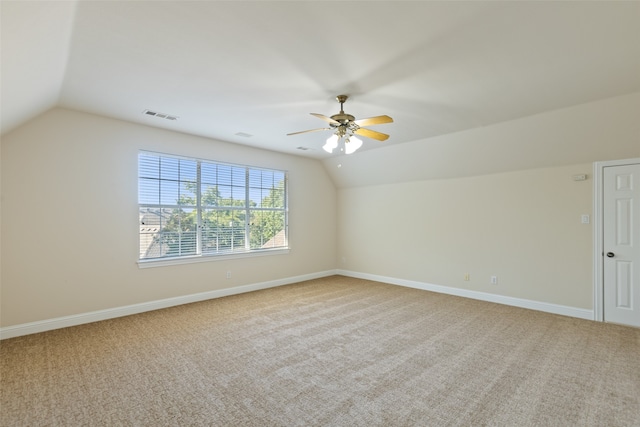 unfurnished room with carpet, lofted ceiling, and ceiling fan