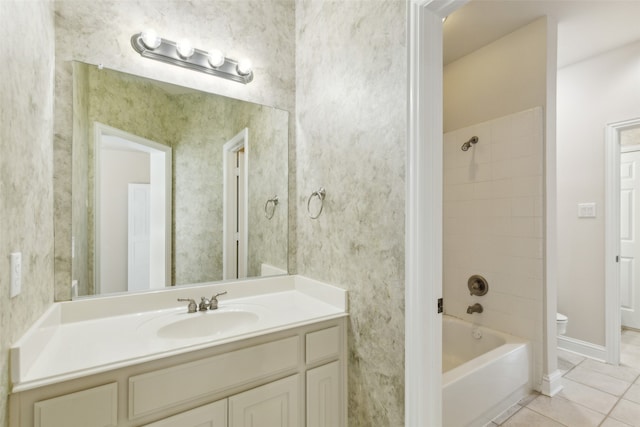 full bathroom with vanity, tiled shower / bath, tile patterned floors, and toilet