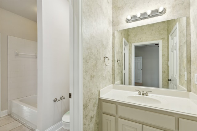 full bathroom featuring tile patterned flooring, vanity, toilet, and  shower combination