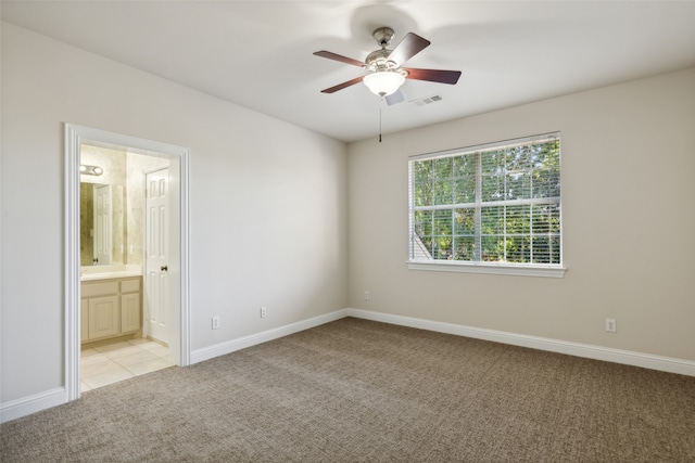 carpeted spare room with ceiling fan