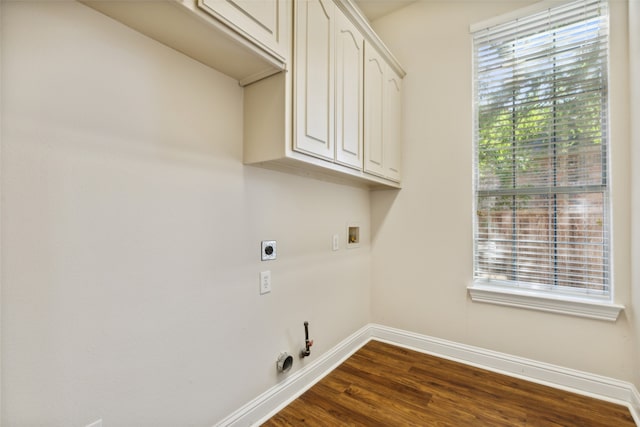 laundry room with hookup for a washing machine, cabinets, dark hardwood / wood-style flooring, and a wealth of natural light