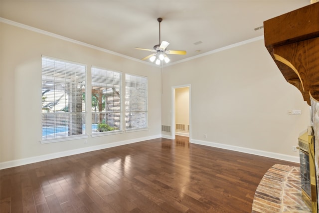 unfurnished living room featuring ornamental molding, ceiling fan, a fireplace, and dark hardwood / wood-style flooring