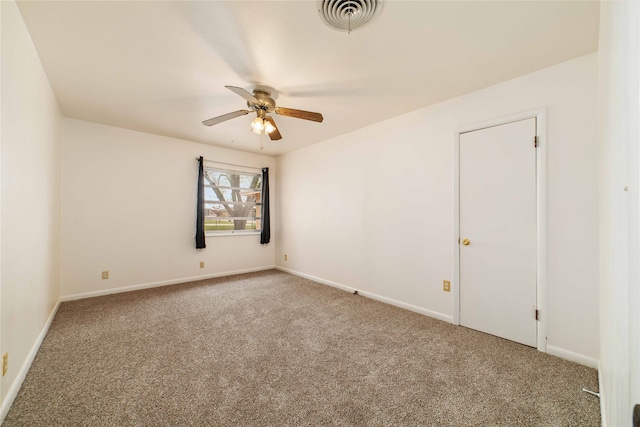 empty room with ceiling fan and carpet floors