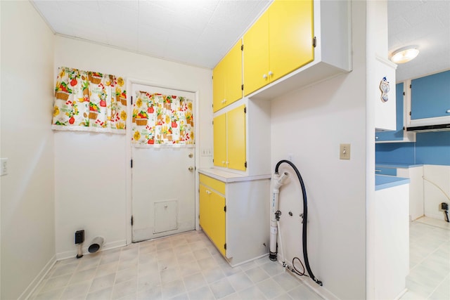 laundry room featuring cabinets