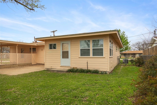 back of house featuring a patio area, a lawn, and cooling unit