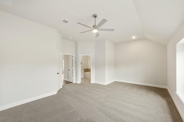 carpeted empty room featuring ceiling fan and lofted ceiling