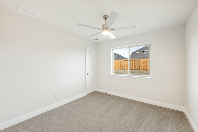 carpeted spare room with ceiling fan