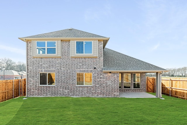 back of house with a patio area and a yard