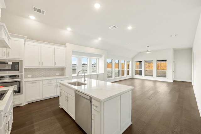 kitchen with sink, white cabinetry, appliances with stainless steel finishes, and tasteful backsplash