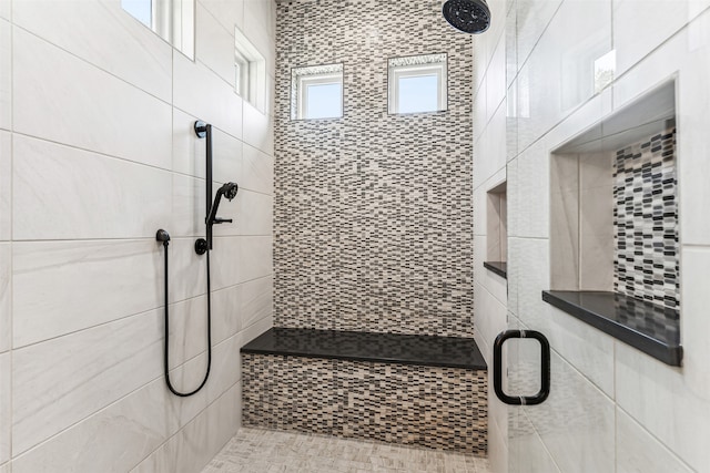 bathroom with a shower with door