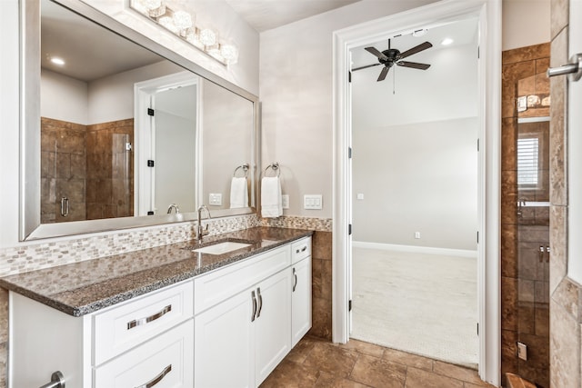 bathroom with ceiling fan, vanity, and an enclosed shower