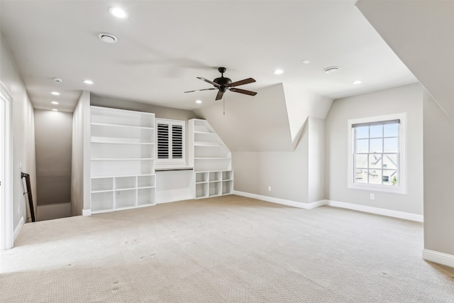 additional living space with ceiling fan, lofted ceiling, and carpet flooring