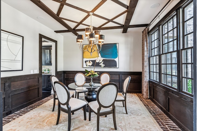 dining area featuring plenty of natural light, coffered ceiling, and an inviting chandelier