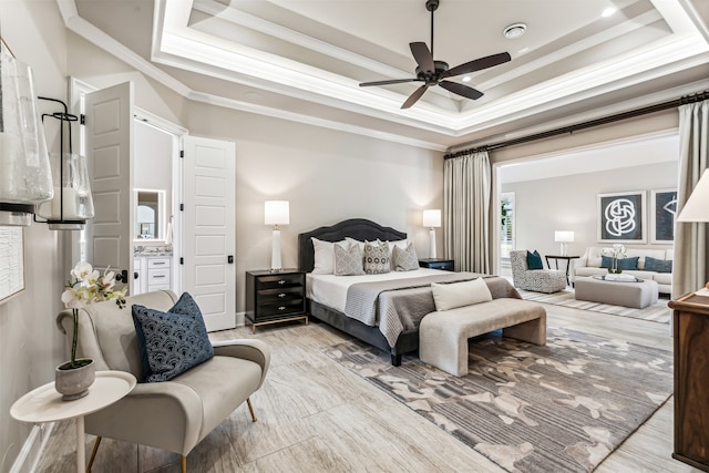 bedroom with ornamental molding, a tray ceiling, and ceiling fan