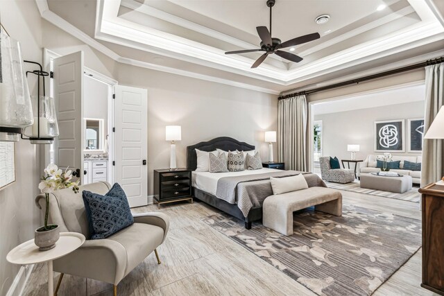 bedroom with crown molding, a ceiling fan, and a tray ceiling