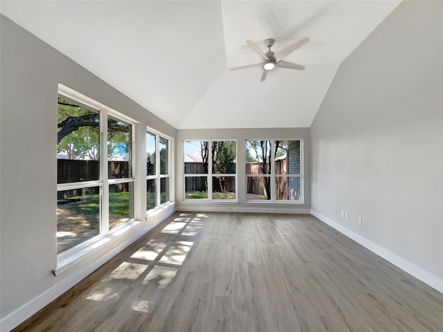 interior space with a healthy amount of sunlight, ceiling fan, and vaulted ceiling