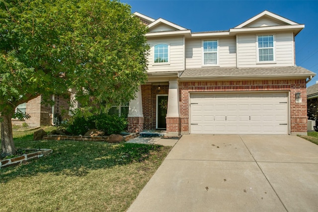 view of front of house with a front yard and a garage