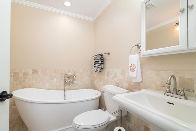 bathroom featuring a bathing tub, crown molding, tile walls, toilet, and sink