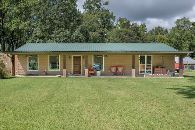 view of front facade featuring a jacuzzi, a front lawn, and a patio