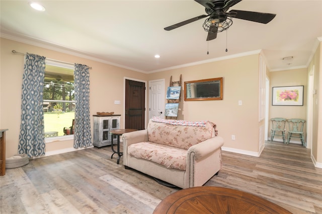 living area with ornamental molding, recessed lighting, light wood-style floors, baseboards, and ceiling fan