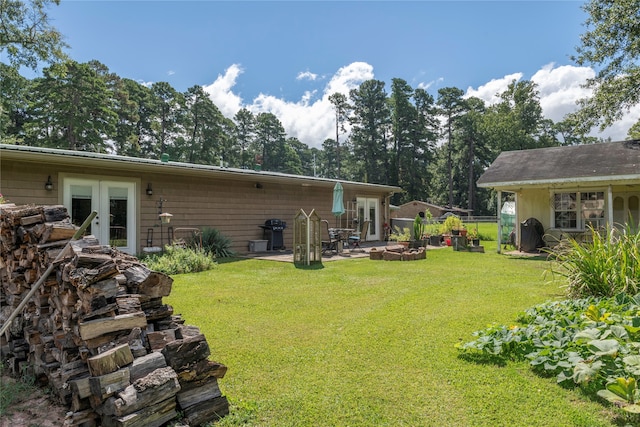 rear view of property featuring french doors, a yard, and a patio