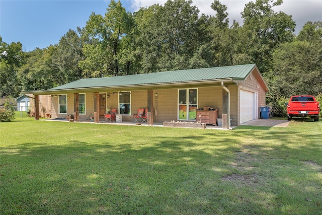 single story home featuring a front lawn, a garage, and an outdoor structure