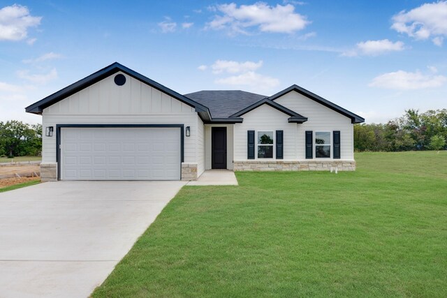 view of front of house featuring a garage and a front lawn