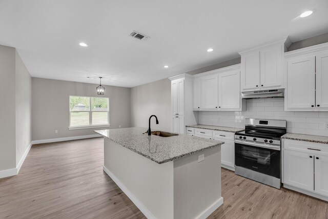 kitchen featuring light hardwood / wood-style floors, white cabinetry, sink, and stainless steel range oven