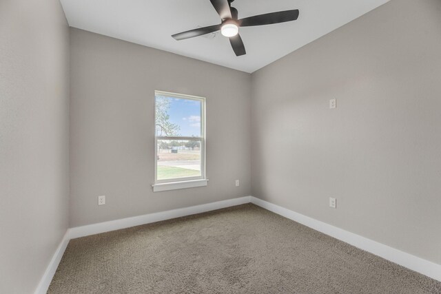 spare room featuring ceiling fan and carpet floors