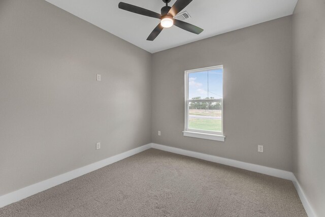 spare room featuring ceiling fan and carpet