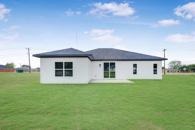 rear view of house featuring a patio area and a yard