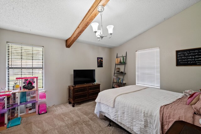 carpeted bedroom featuring an inviting chandelier