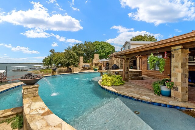 view of pool featuring a water view and a patio