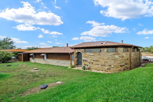 rear view of house with a yard