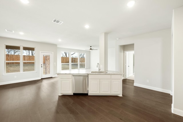 kitchen with dishwasher, sink, white cabinets, dark wood-type flooring, and light stone counters