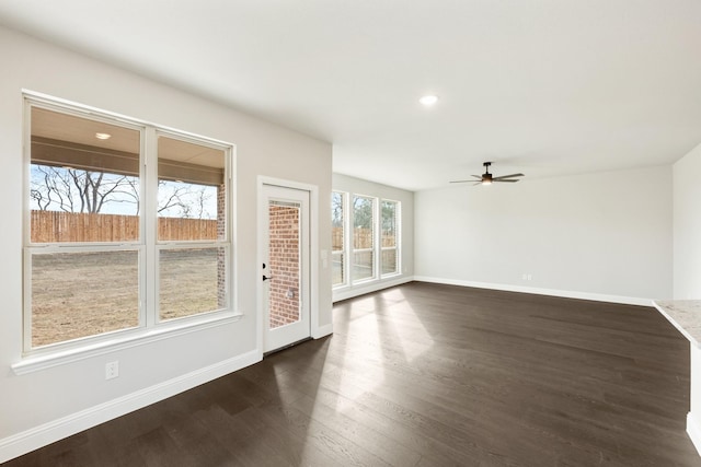 empty room with ceiling fan and dark hardwood / wood-style floors