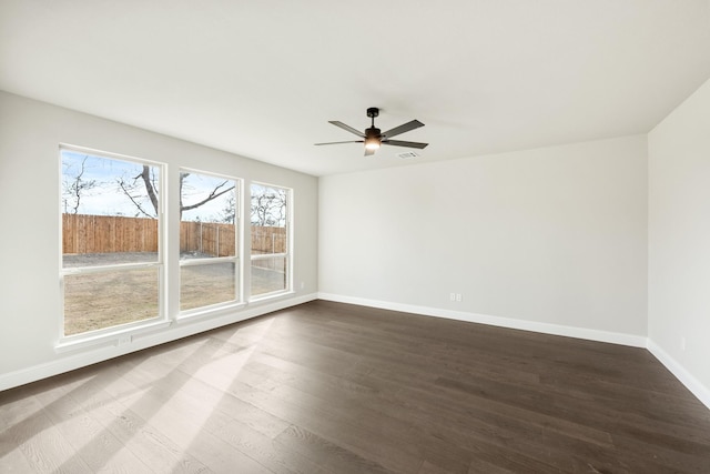 empty room featuring ceiling fan and dark hardwood / wood-style flooring