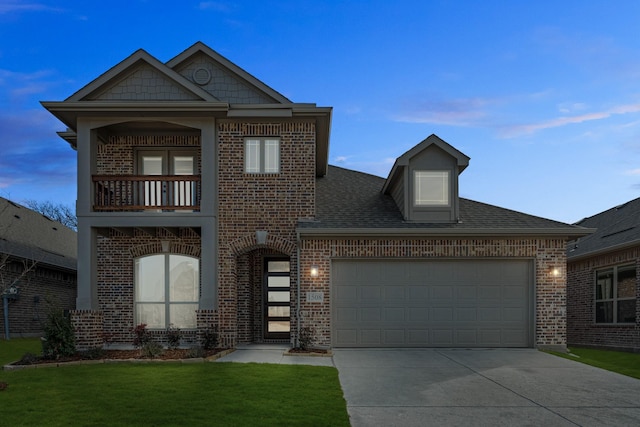 view of front of house with a balcony, a garage, and a lawn