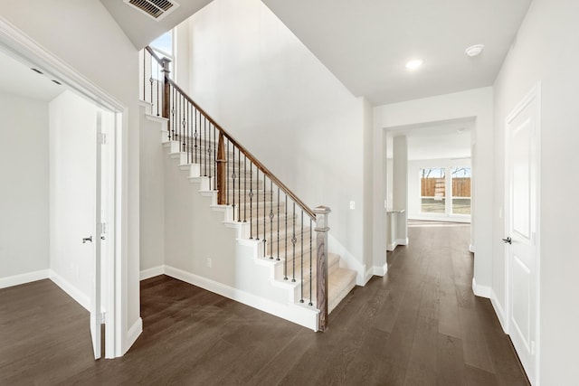 staircase with wood-type flooring