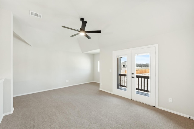 spare room with ceiling fan, carpet, lofted ceiling, and french doors