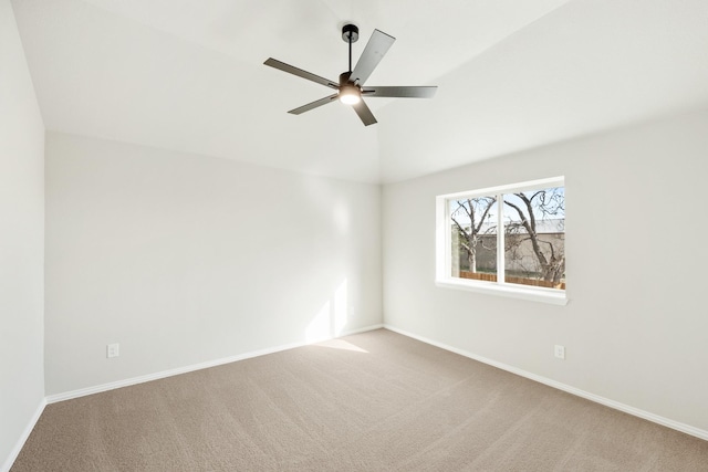 carpeted spare room featuring ceiling fan and lofted ceiling