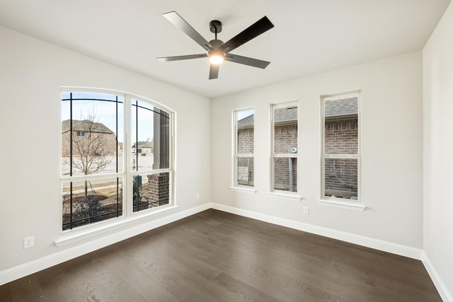 spare room featuring ceiling fan and dark hardwood / wood-style floors